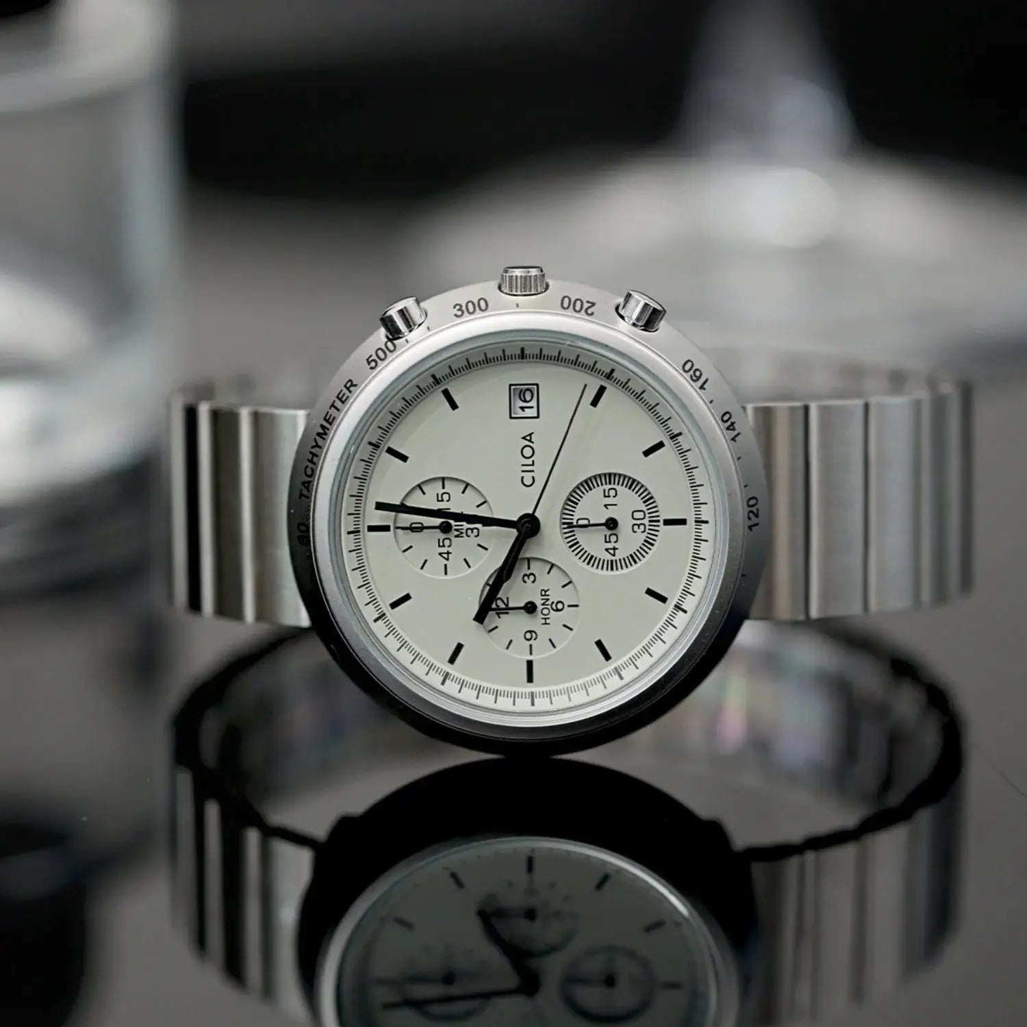 CILOA men's silver round chronograph watch with large dial, tachymeter bezel, and stainless steel bracelet.