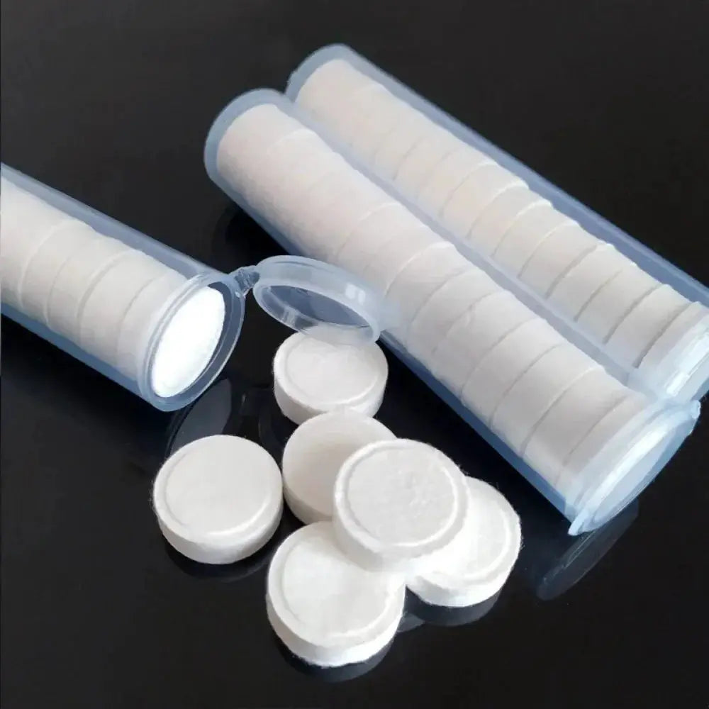 Compressed towels; white non-woven face towels in portable tubes, 20 pcs
