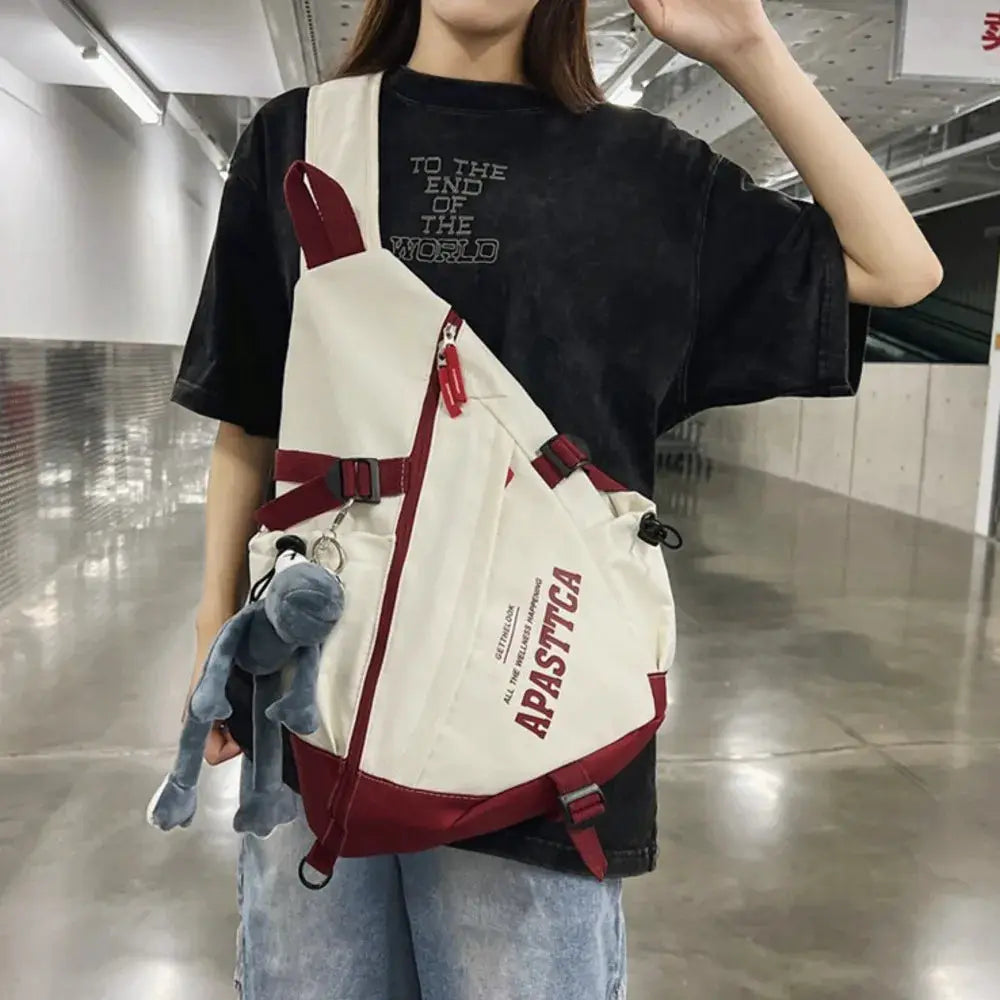 Simples Market nylon crossbody bag, white with red accents, unisex travel bag with blue plush keychain.