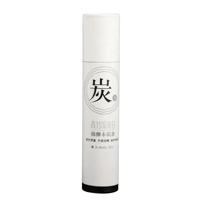 Charcoal drawing sticks in a white cylindrical container with a black cap and Chinese label.