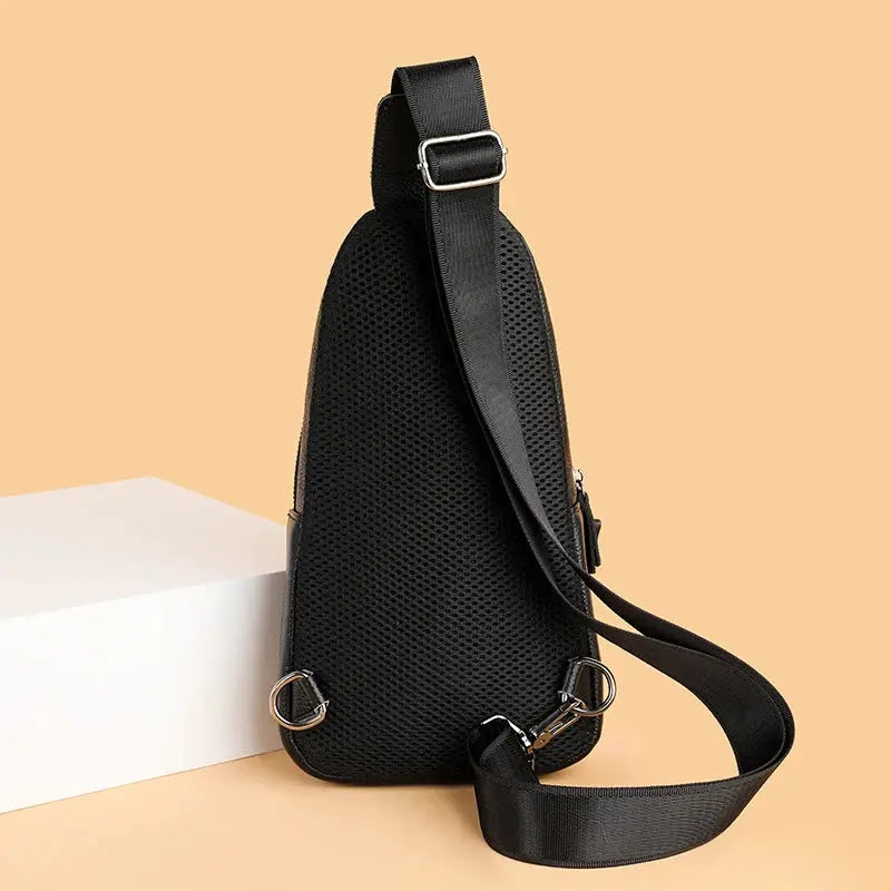 Men's black genuine leather chest bag with adjustable crossbody strap