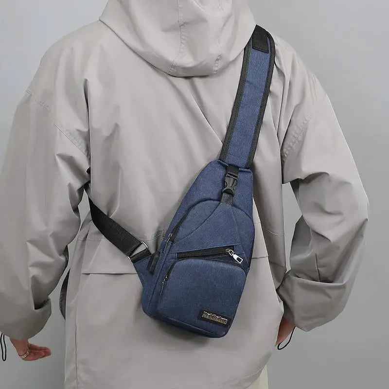 Men's blue canvas chest bag with multiple zip pockets and adjustable crossbody strap; Simples Market.
