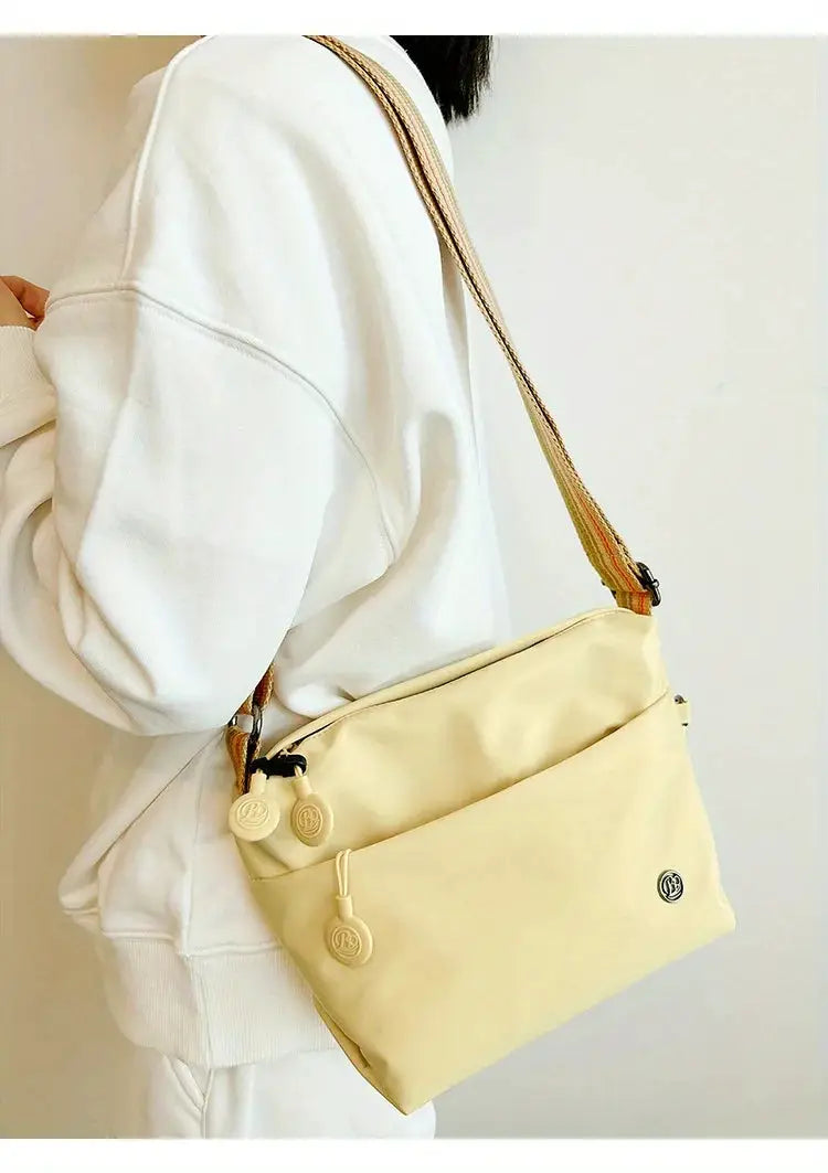 Nylon crossbody bag by Simples Market, beige with adjustable wide strap and zipper closure