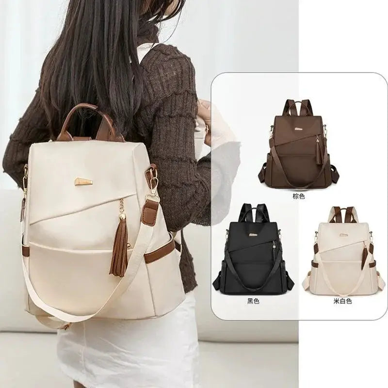 Nylon anti-theft backpack by Simples Market with tassel decor; beige, large-capacity casual travel bag