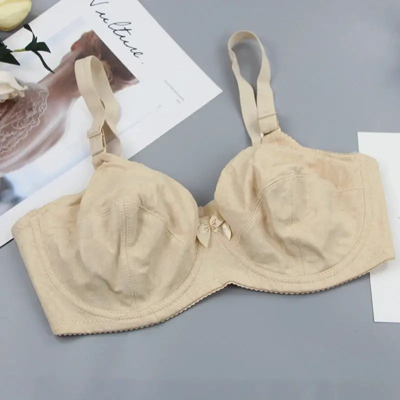 Beige bra with bow detail, adjustable straps, smooth cups