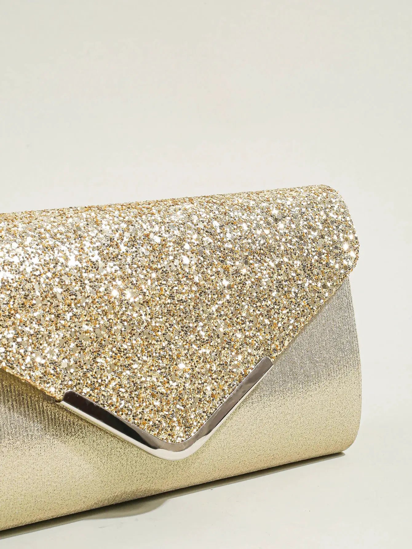 Women evening sequin envelope clutch by Simples Market; gold sparkly front with metallic frame.