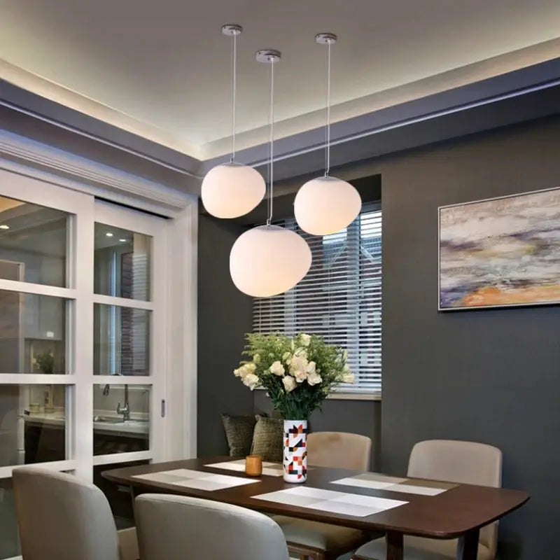Nordic Creative White Glass Ball Pendant lights, 3 hanging fixtures over a dining table by Simples Market