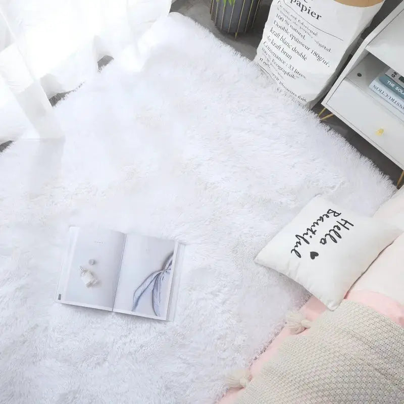 Kids fluffy white rug, soft shag carpet for bedroom or living room with an open book nearby