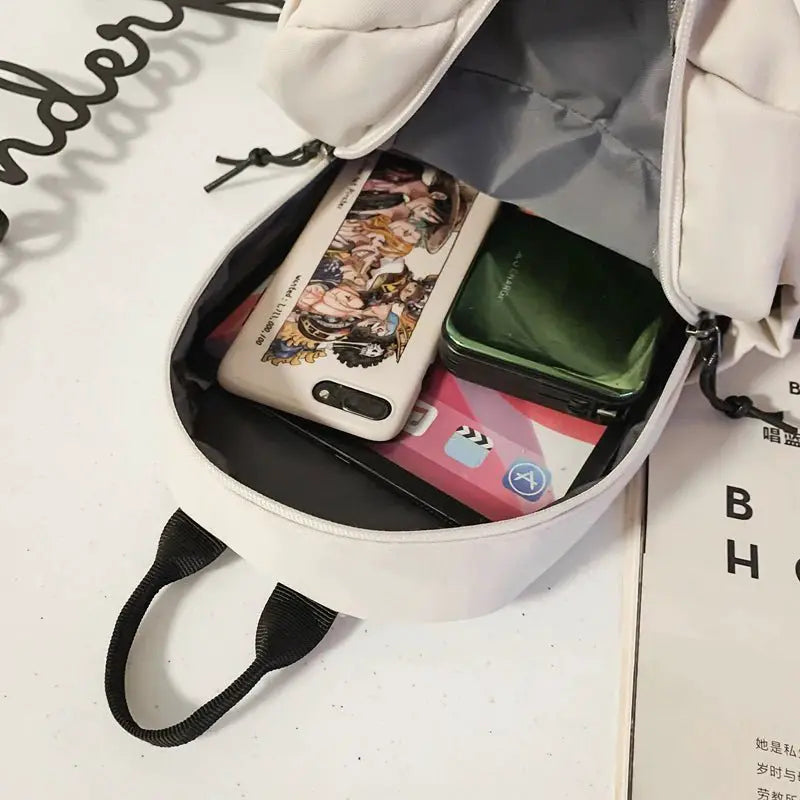 Interior view of a lightweight crossbody tablet bag showing a phone, tablet, and essentials neatly organized.