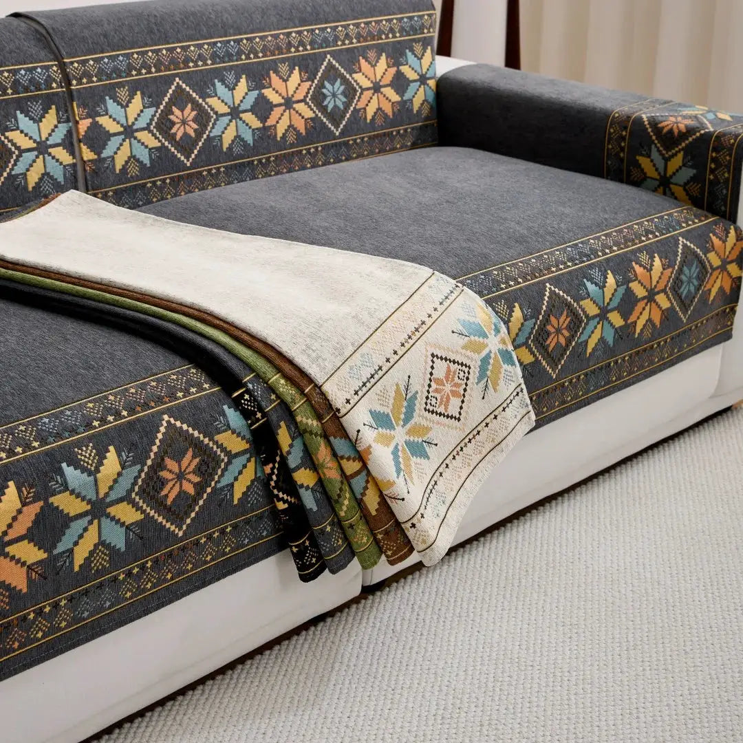 Bohemian jacquard chenille sofa throw by Simples Market with geometric multicolor pattern on dark gray sofa