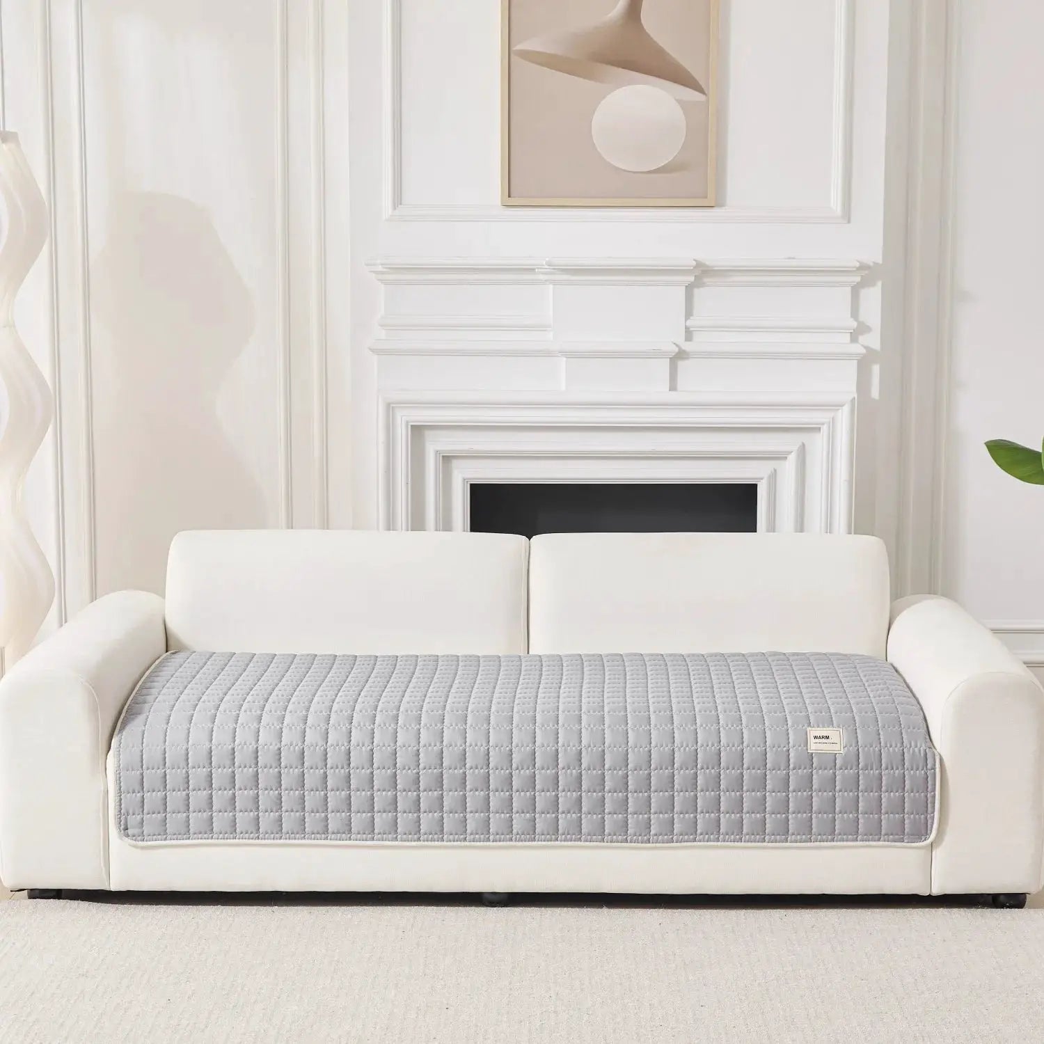 Sofa slipcover Simples Market gray quilted anti-slip on white sofa