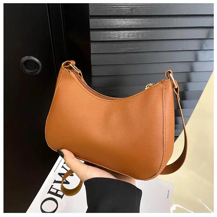 Handbag tan faux leather with a single shoulder strap and curved-square silhouette