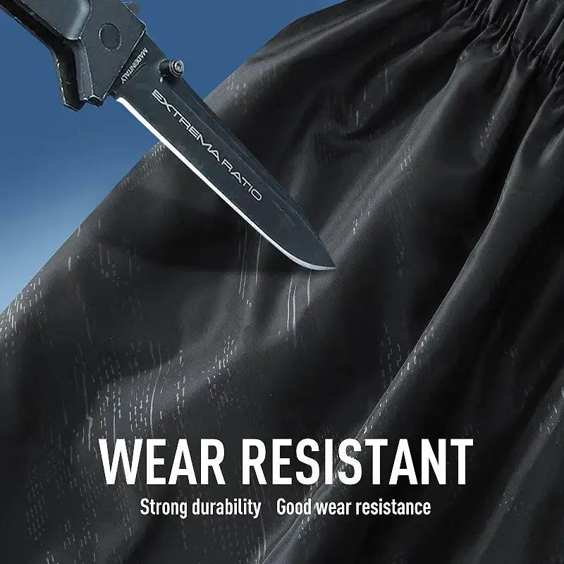 LNGXO waterproof hiking pants fabric wear-resistant test with knife on dark material