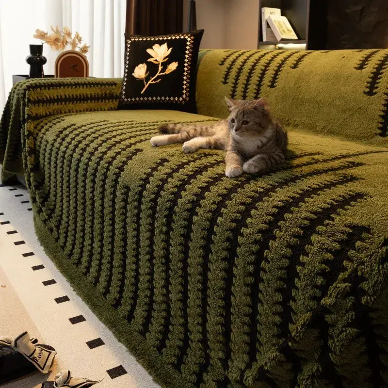 Thick jacquard fleece sofa throw blanket in olive green with tufted pattern on a living room couch