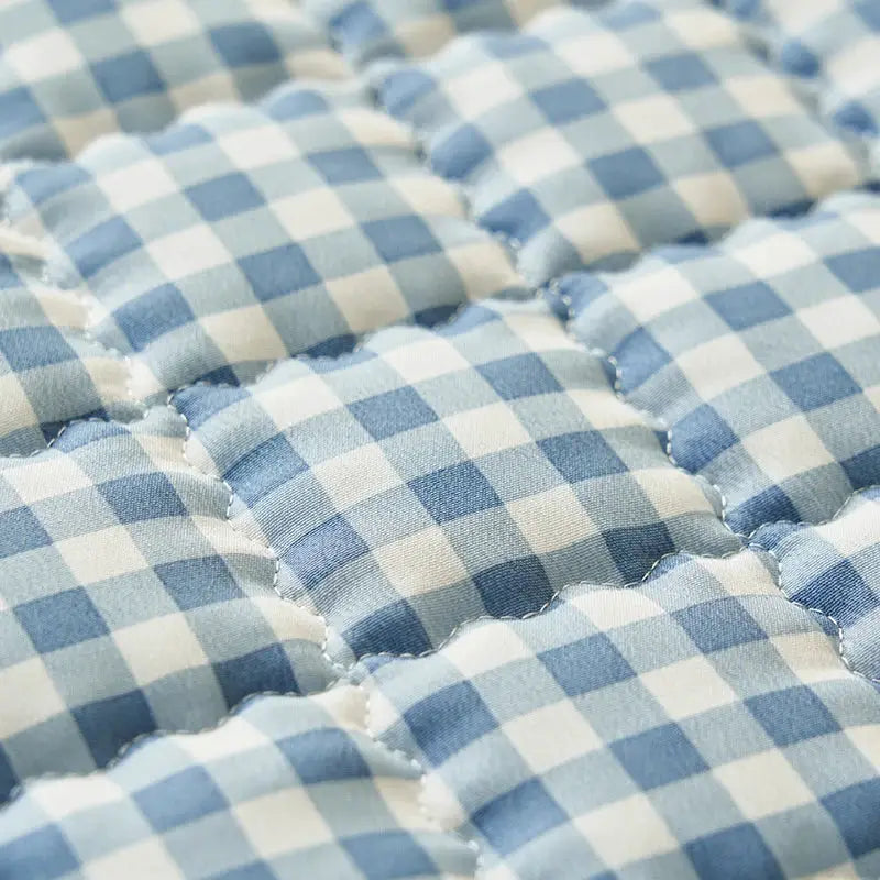 Quilted plaid mattress cover in blue and white gingham, breathable antibacterial fabric