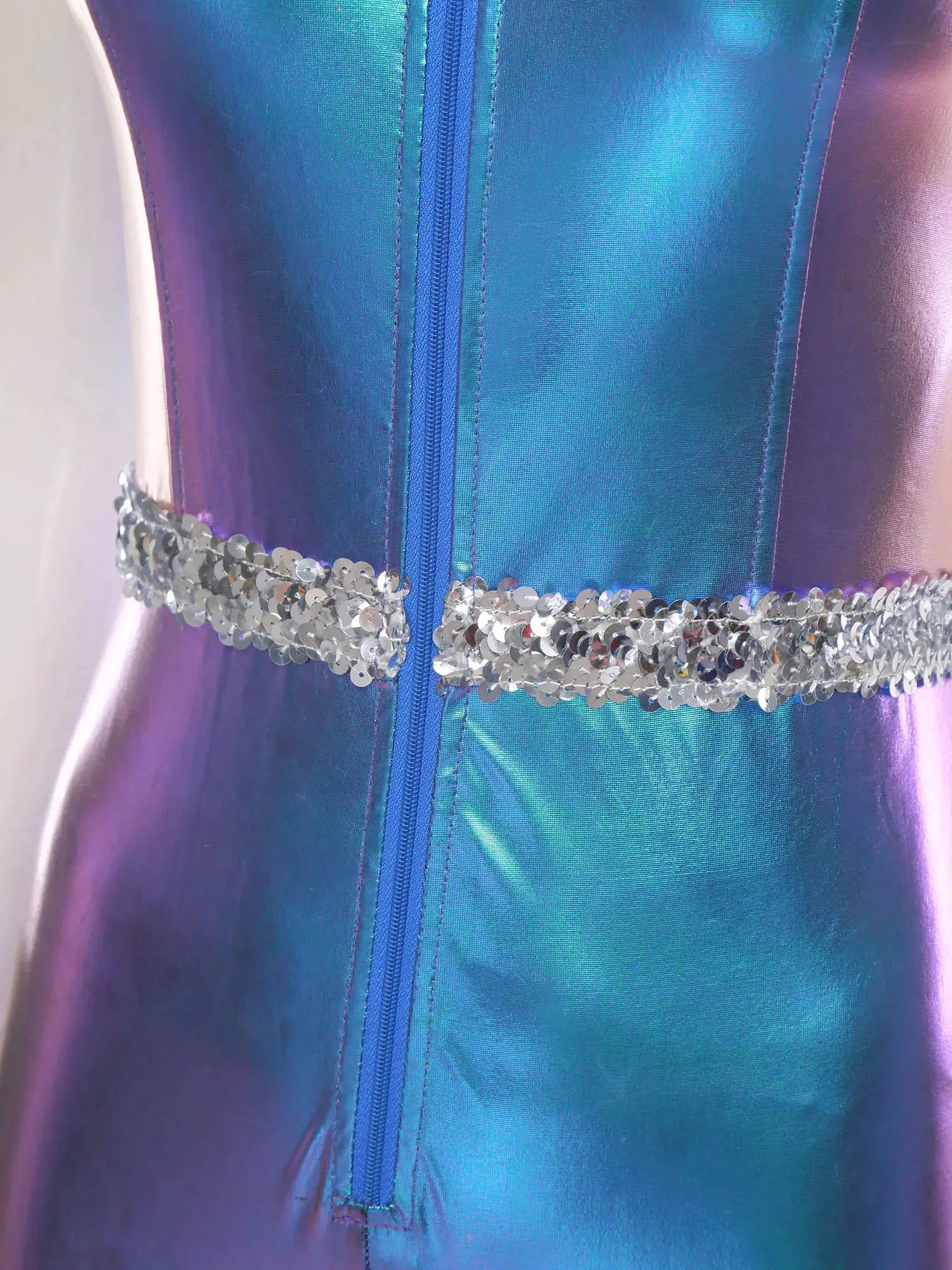 Adult womens disco jumpsuit in metallic blue-to-purple gradient with front zipper and silver sequin belt