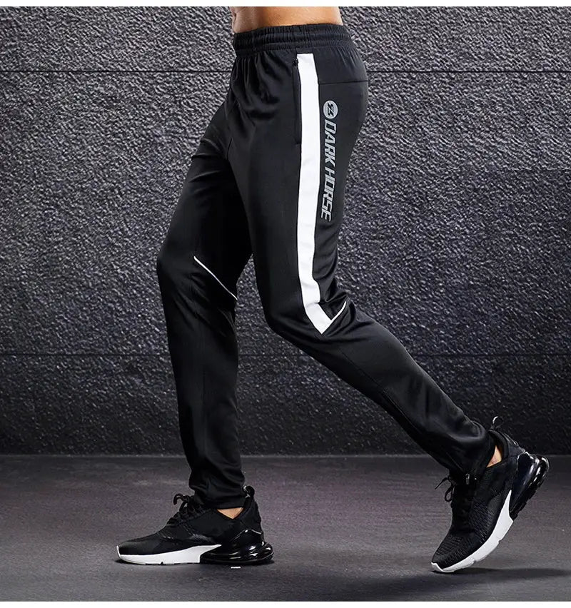 Men's sport pants with white side stripe and zip pockets, black joggers for training