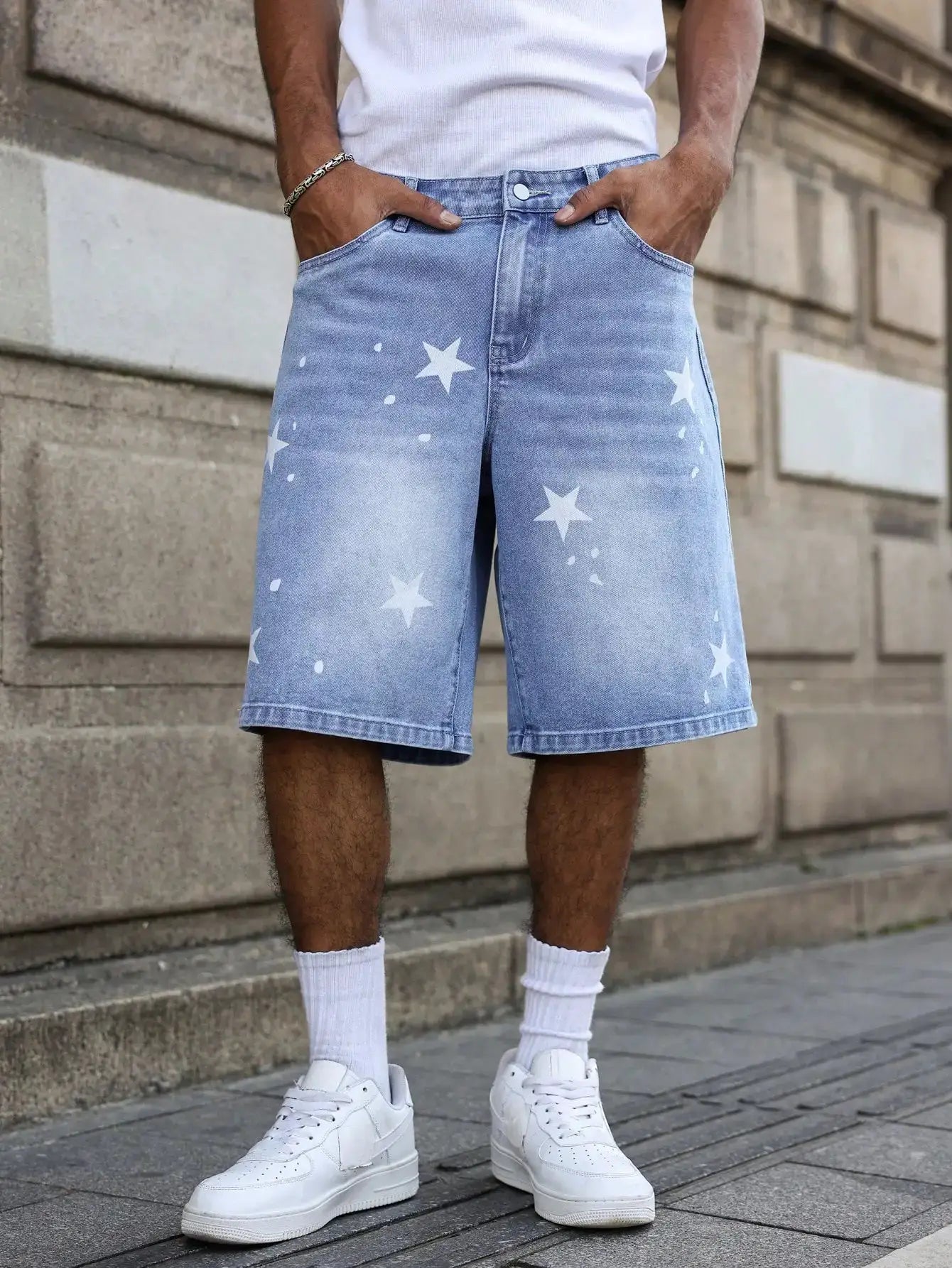 Men's blue denim shorts with white star prints, knee-length for summer wear