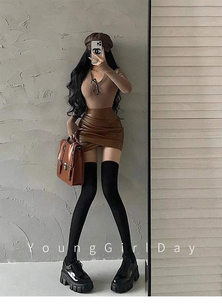 WOMENGAGA brown PU leather wrap mini skirt, high-waisted, paired with black thigh-high socks and chunky platform heels