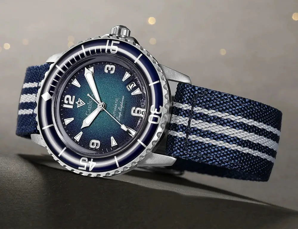 CADISEN Deep Explorer wristwatch with blue dial, stainless steel case, and navy striped canvas strap