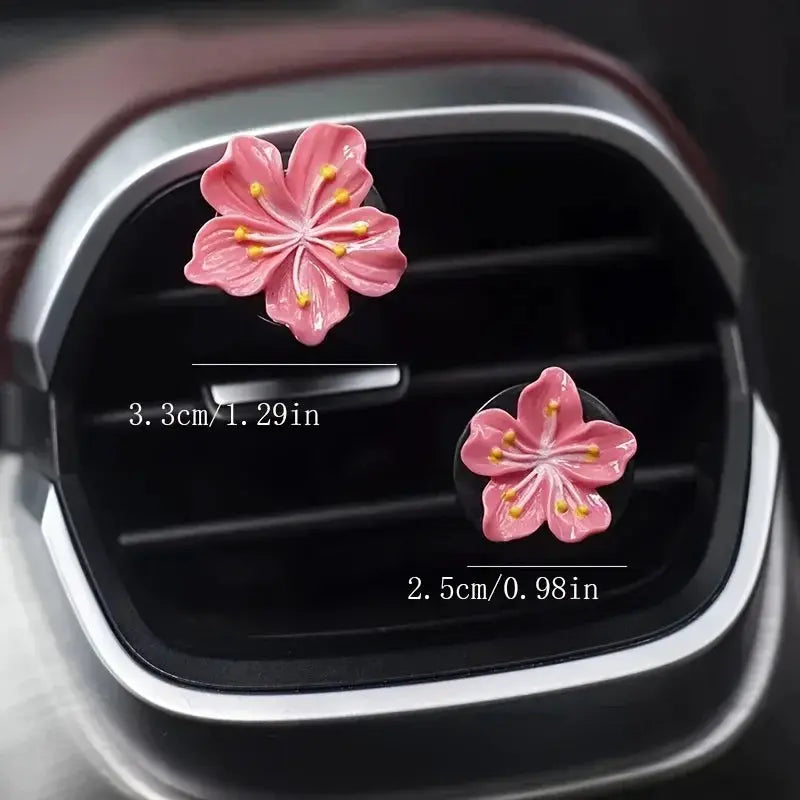 2pcs pink flower car perfume clips for air vent, sizes 3.3cm and 2.5cm.