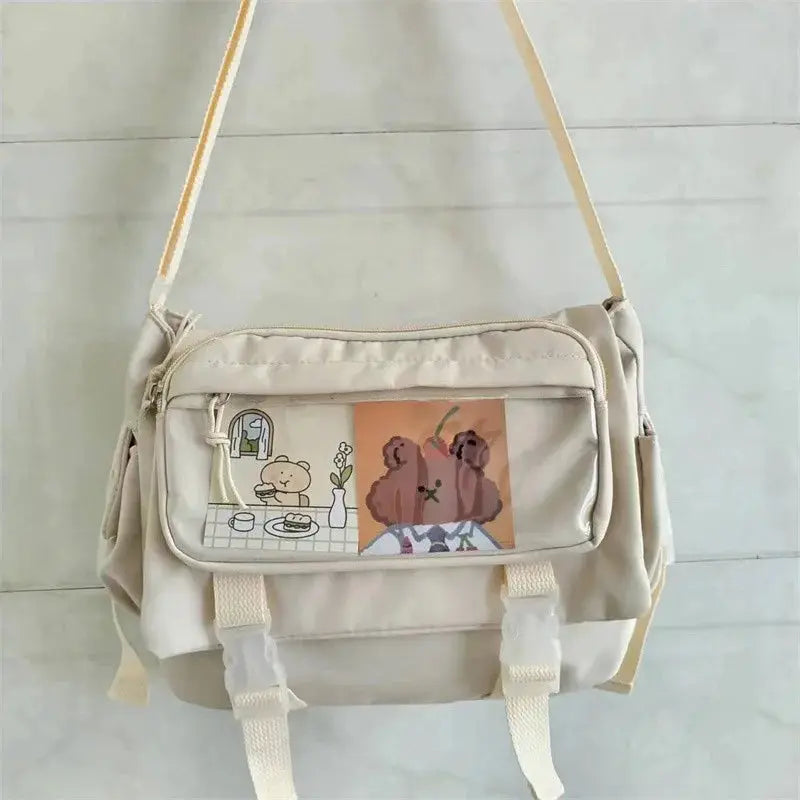 Large-capacity beige canvas crossbody bag with front print panel and adjustable strap