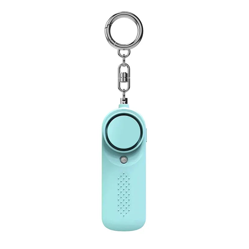 Simples Market Protect Alert 130dB personal defense siren keychain in turquoise with circular alarm unit.