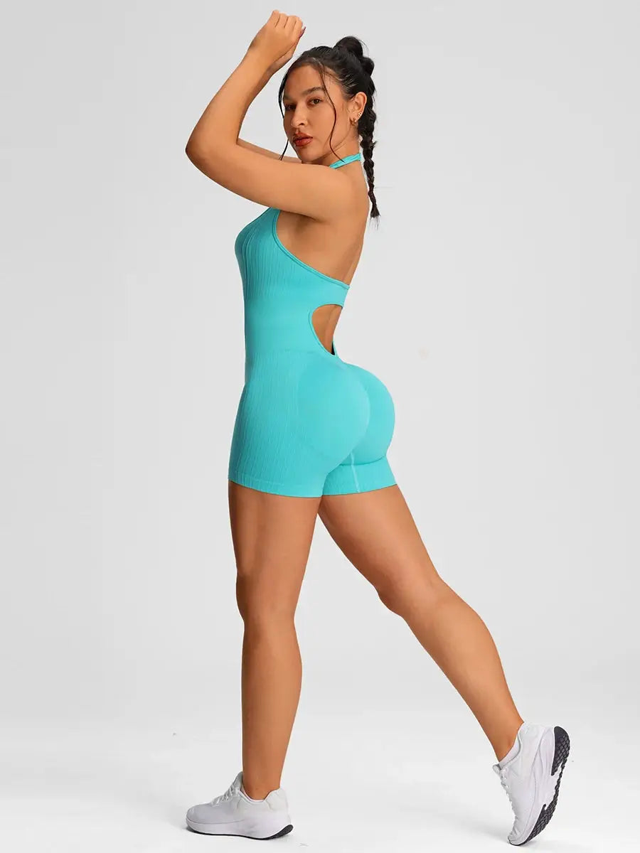 Turquoise women's gym romper with halter neck and side cut-out.