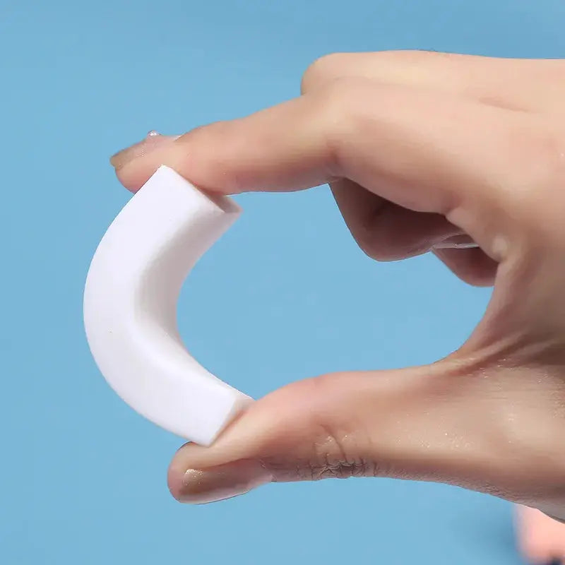 2B eraser by Simples Market, curved white school eraser held between fingers