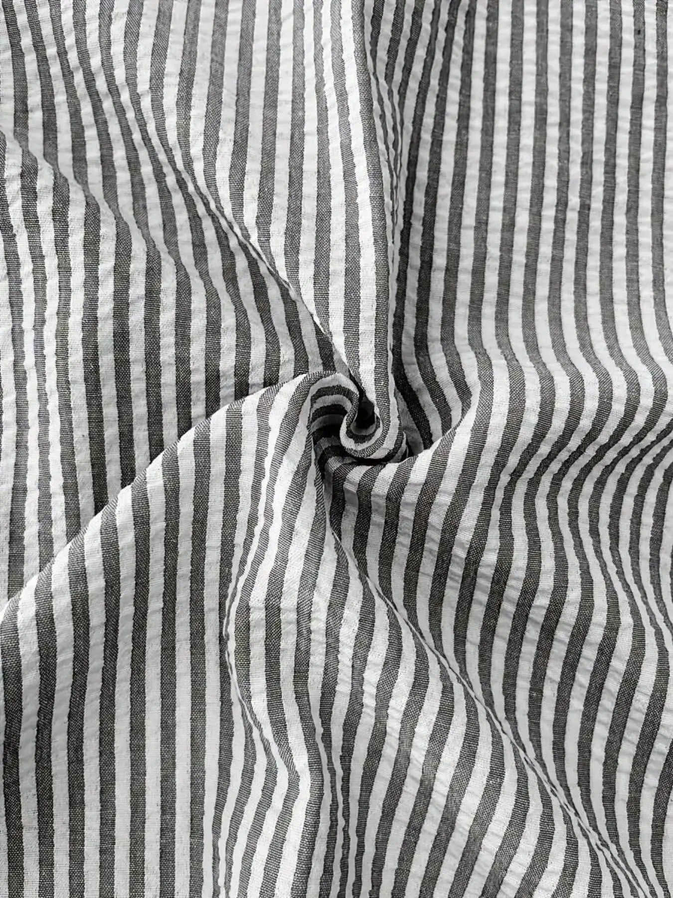 Men's striped long-sleeve shirt fabric close-up with black and white vertical stripes