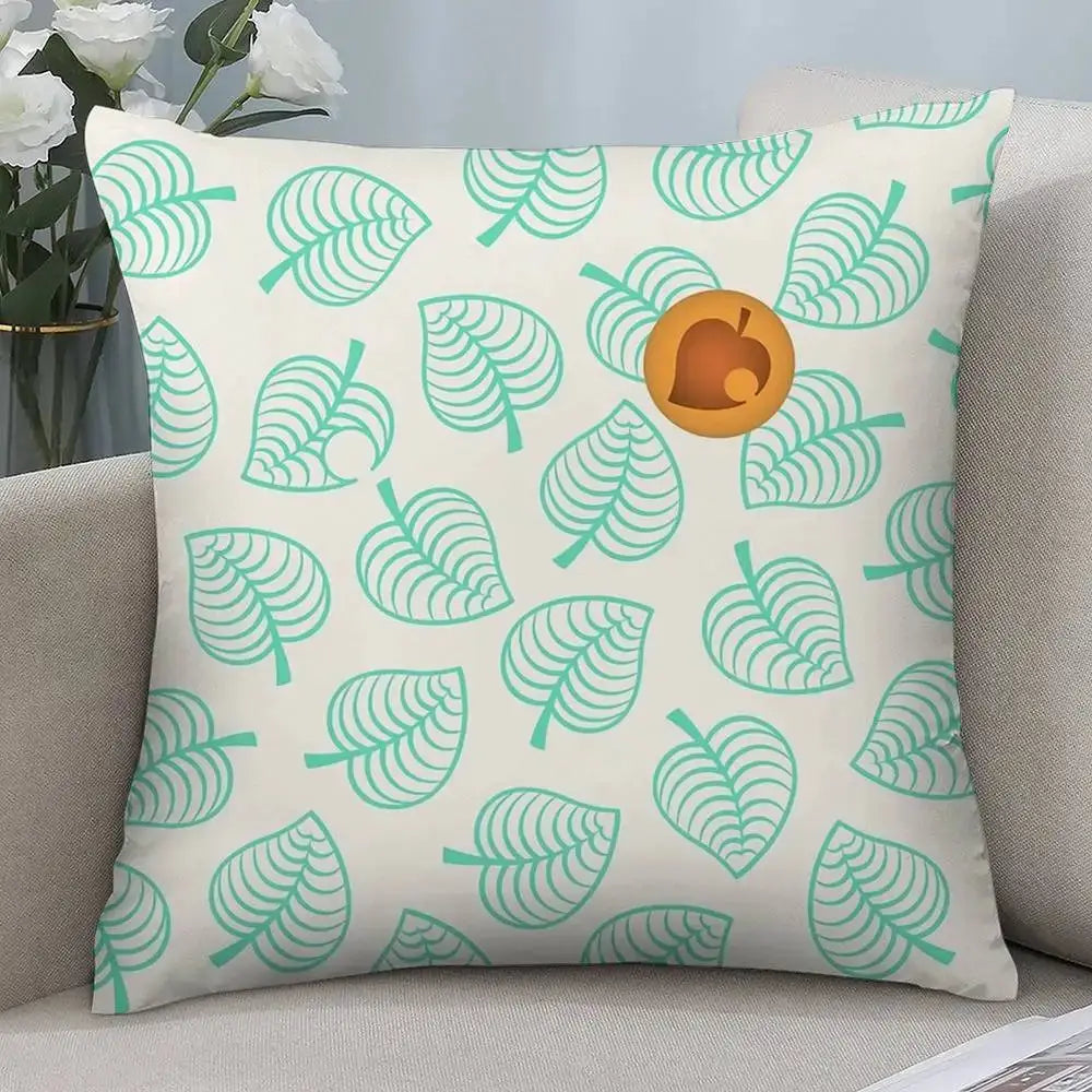 Pillow cover: white square cushion with teal leaf print and small orange pumpkin accent.