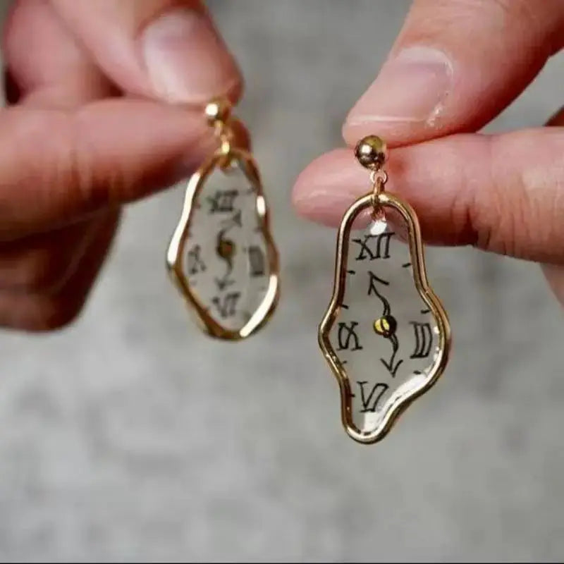 Clock earrings pair with irregular gold-tone frames and clear Roman numerals