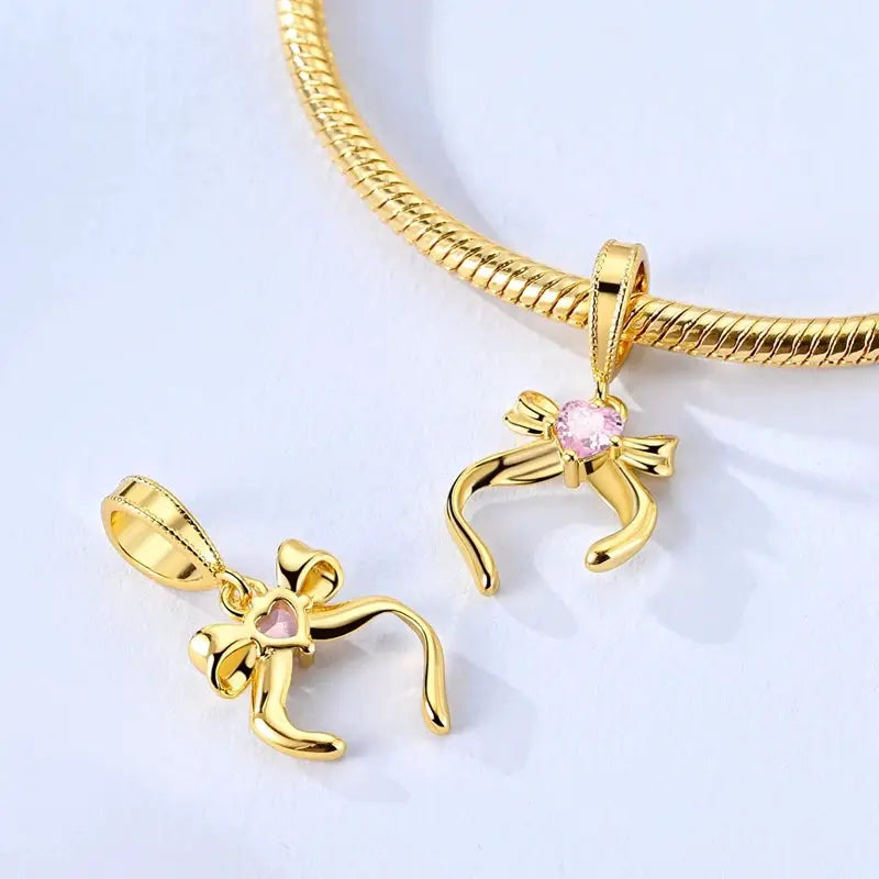 Gold-tone bow pendant charms with pink heart centerpiece, 2-pack for bracelets