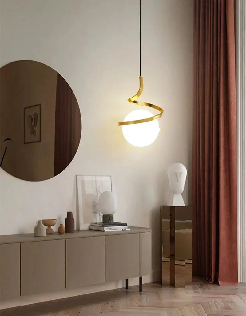 Nordic LED pendant light with a white globe and gold spiral wrap, hung in a modern living room.