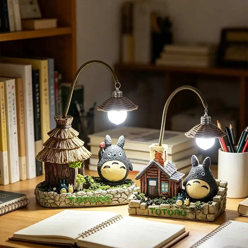 Two Totoro LED desk lamps with gooseneck bulbs on stone bases and gray Totoro figures