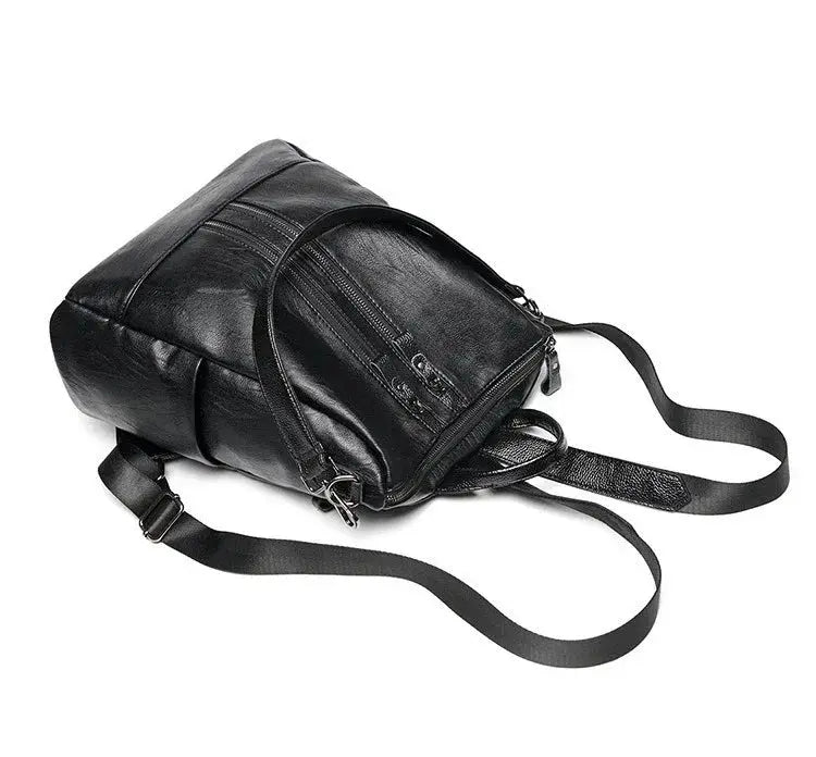 Women's soft leather backpack in black by Simples Market, with multiple zip pockets and adjustable straps