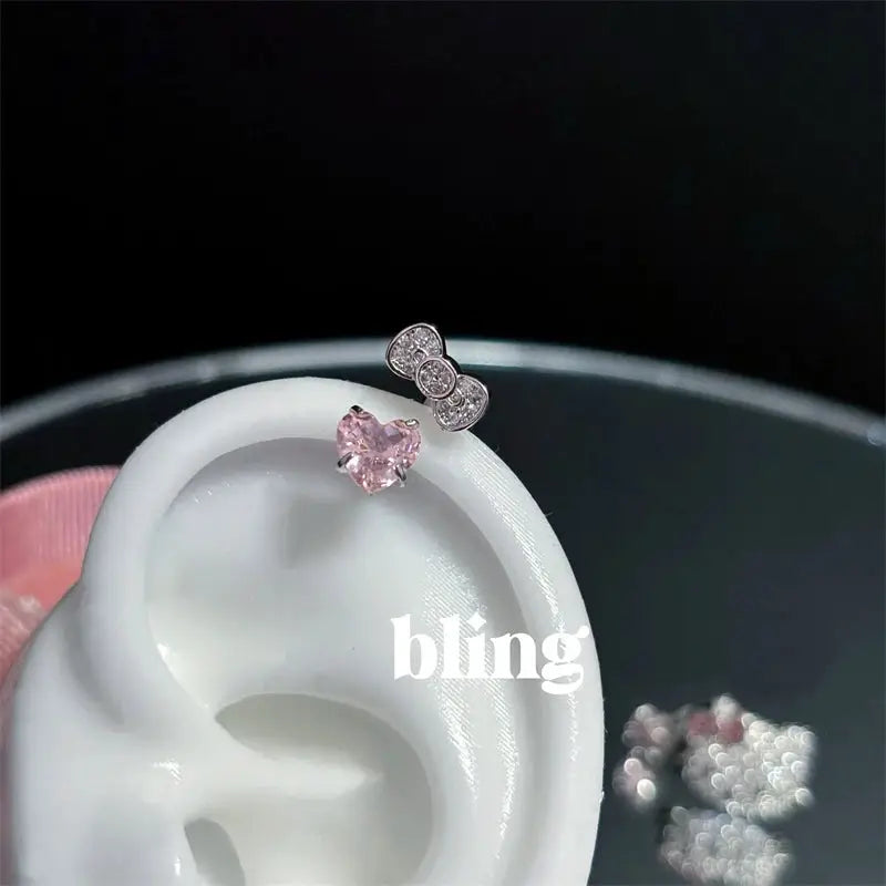 Two-piece stainless steel ear studs: bowknot zircon and pink heart zircon from Simples Market