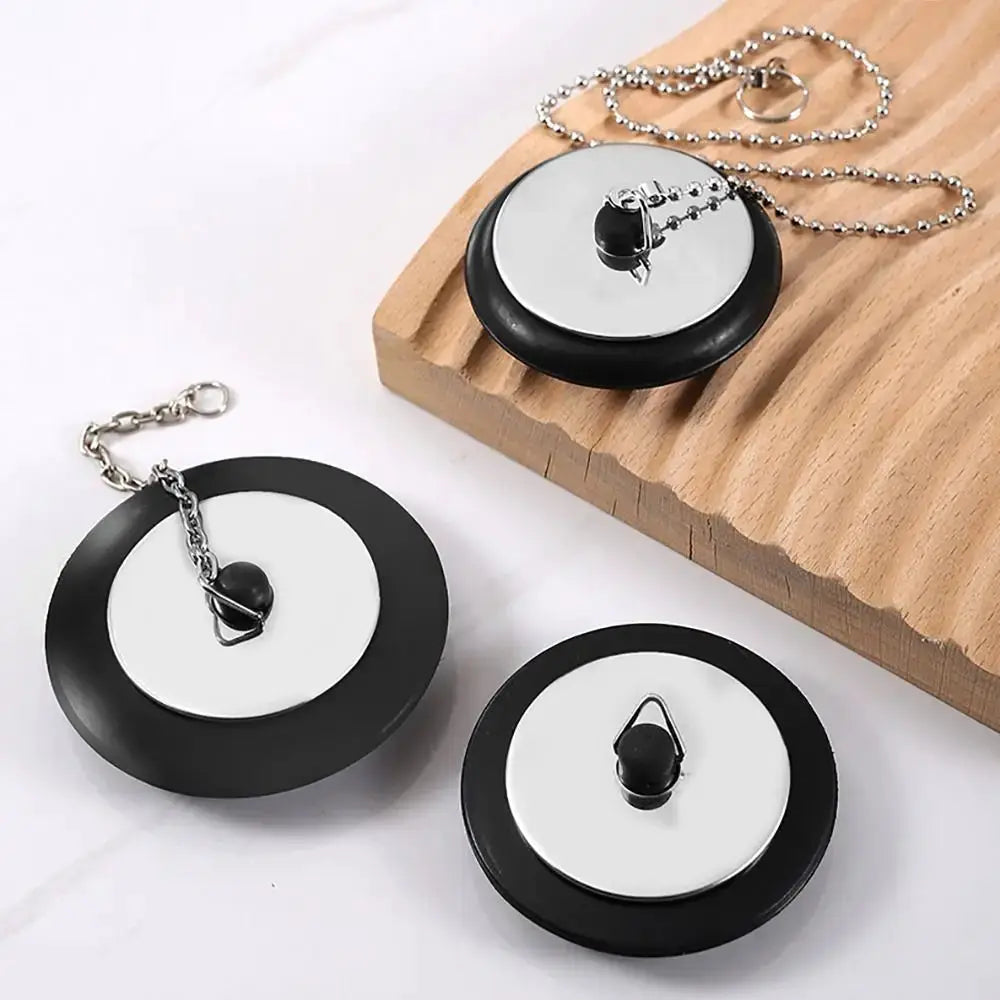 Three Simples Market rubber tub stoppers with chains; black discs with chrome centers, universal 4/4.3/5 cm
