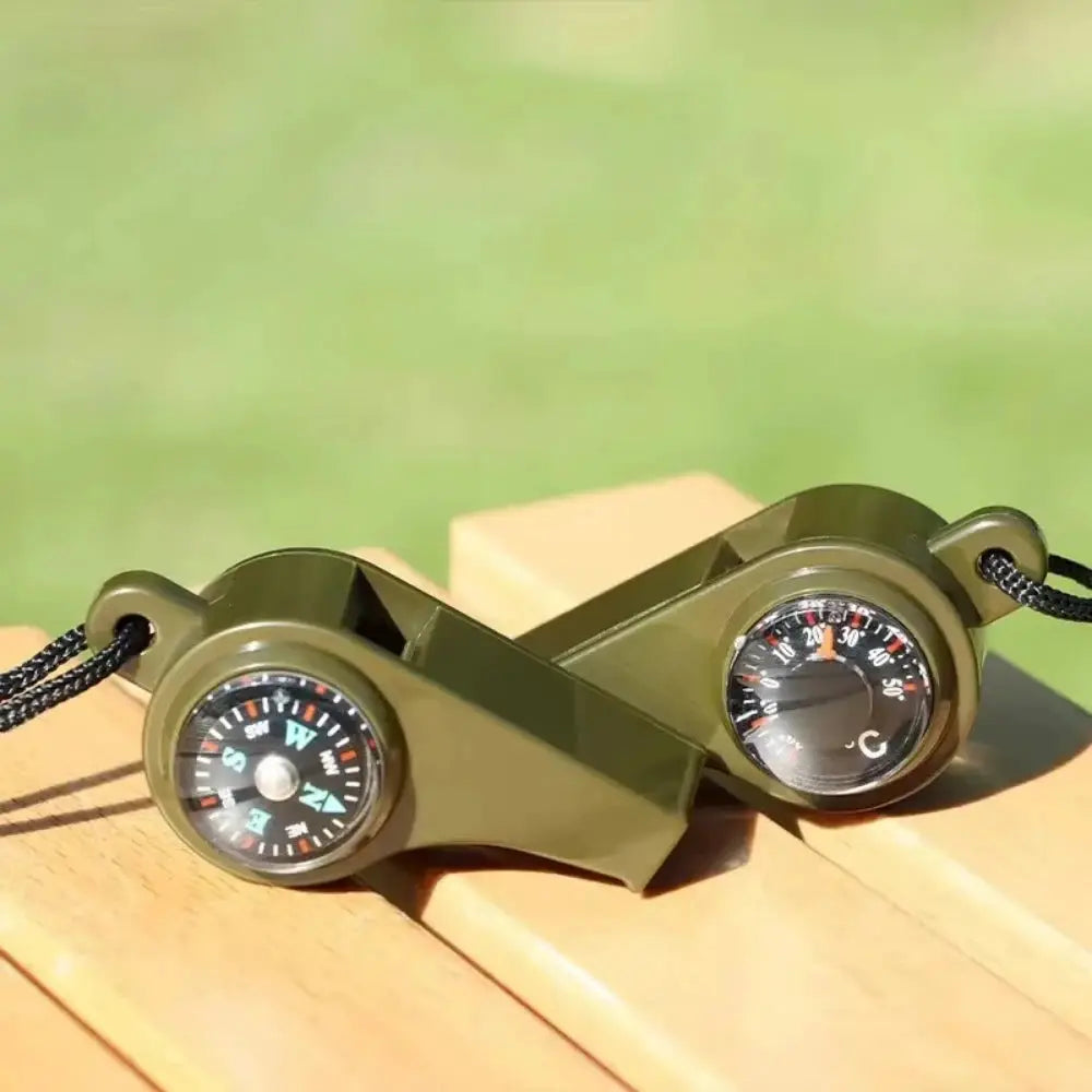 3-in-1 outdoor emergency whistle with built-in compass and thermometer, olive green with a lanyard for camping.