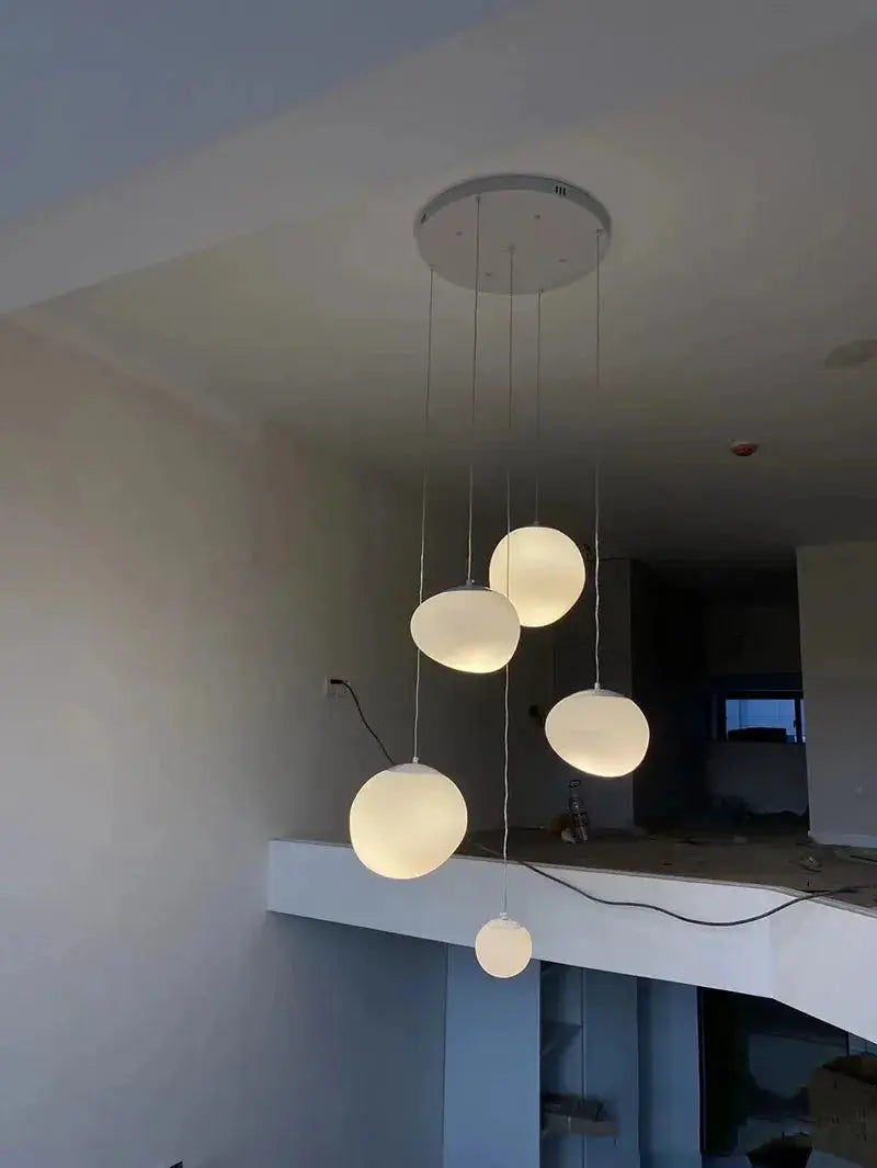 Nordic white glass ball pendant lights, five frosted spheres hanging from a round ceiling mount