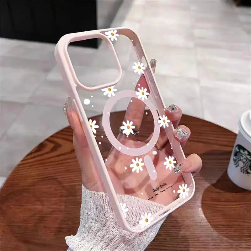 iPhone case with clear pink-tinted back and small white daisy pattern; magnet for wireless charging