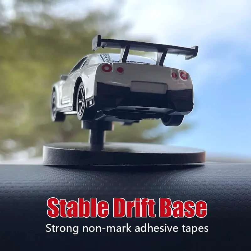 Drift car dashboard toy model on display stand; white body with black rear spoiler.