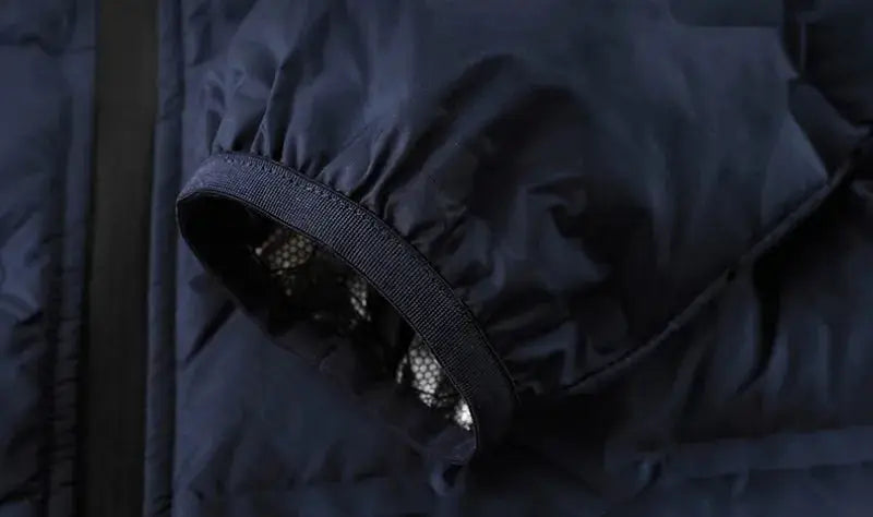 Men's navy down puffer jacket sleeve with elastic cuff, inner mesh lining, close-up view