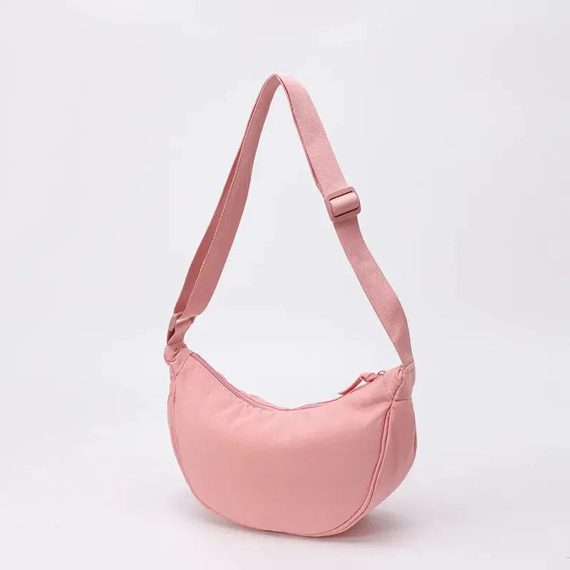 Nylon crossbody bag by Simples Market in pink, crescent dumpling shape with zipper and adjustable strap, large capacity