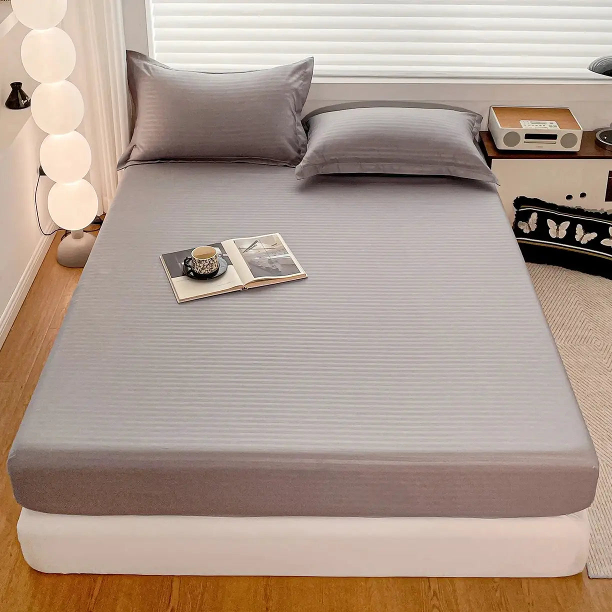 Fitted bed sheet with elastic band in solid gray, soft mattress cover for single to king beds.