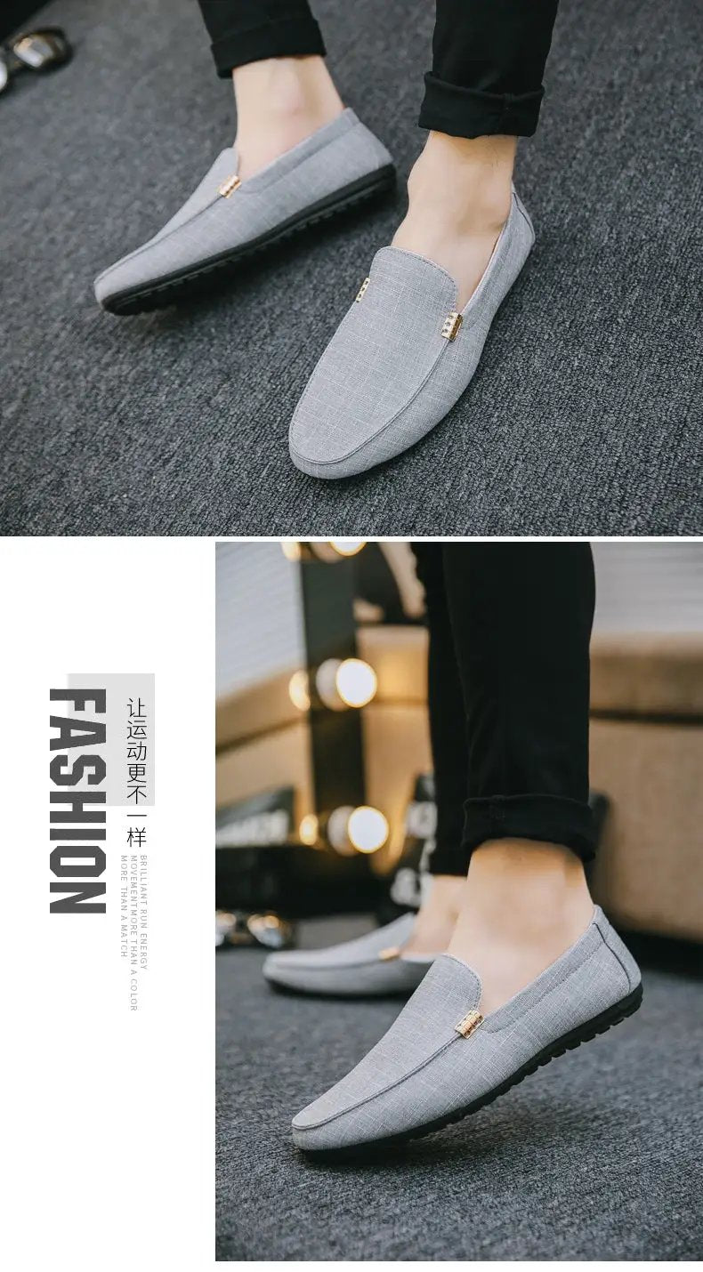 Pair of men's light gray canvas slip-on loafers with subtle check pattern and gold accents; versatile for formal wear.