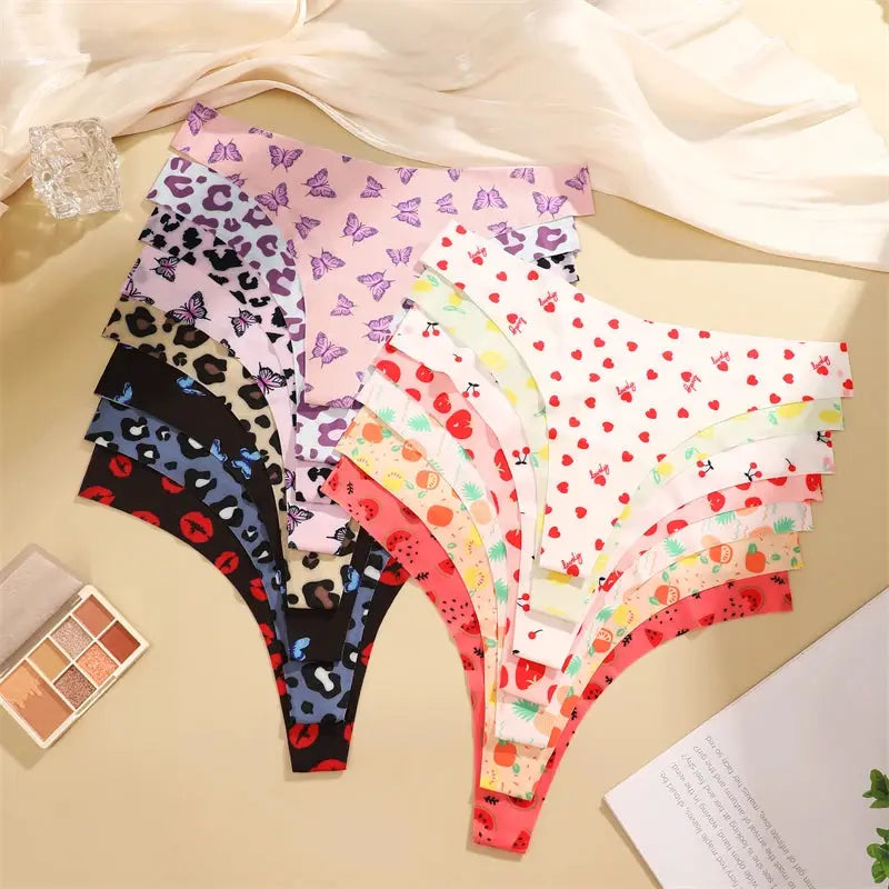 FINETOO 4-pc ultra-soft seamless women's thongs with graphic prints; leopard, butterfly and fruit designs.