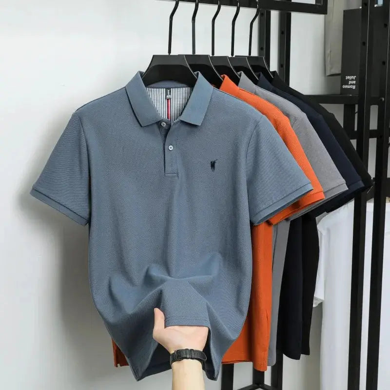Polo shirts on hangers; six 100% cotton polos in assorted colors, front blue with small pony embroidery