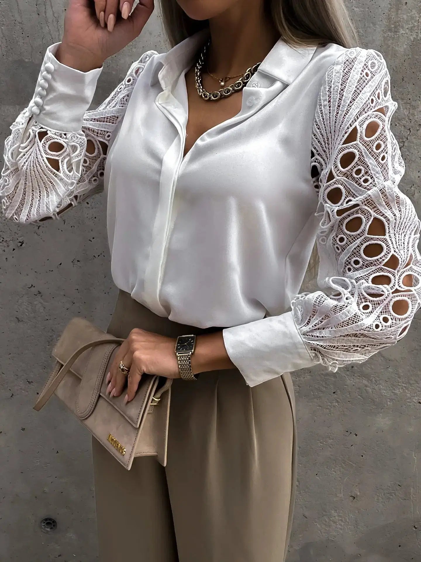 Women white chiffon blouse with intricate lace sleeves; loose V-neck top paired with beige trousers and a tan handbag