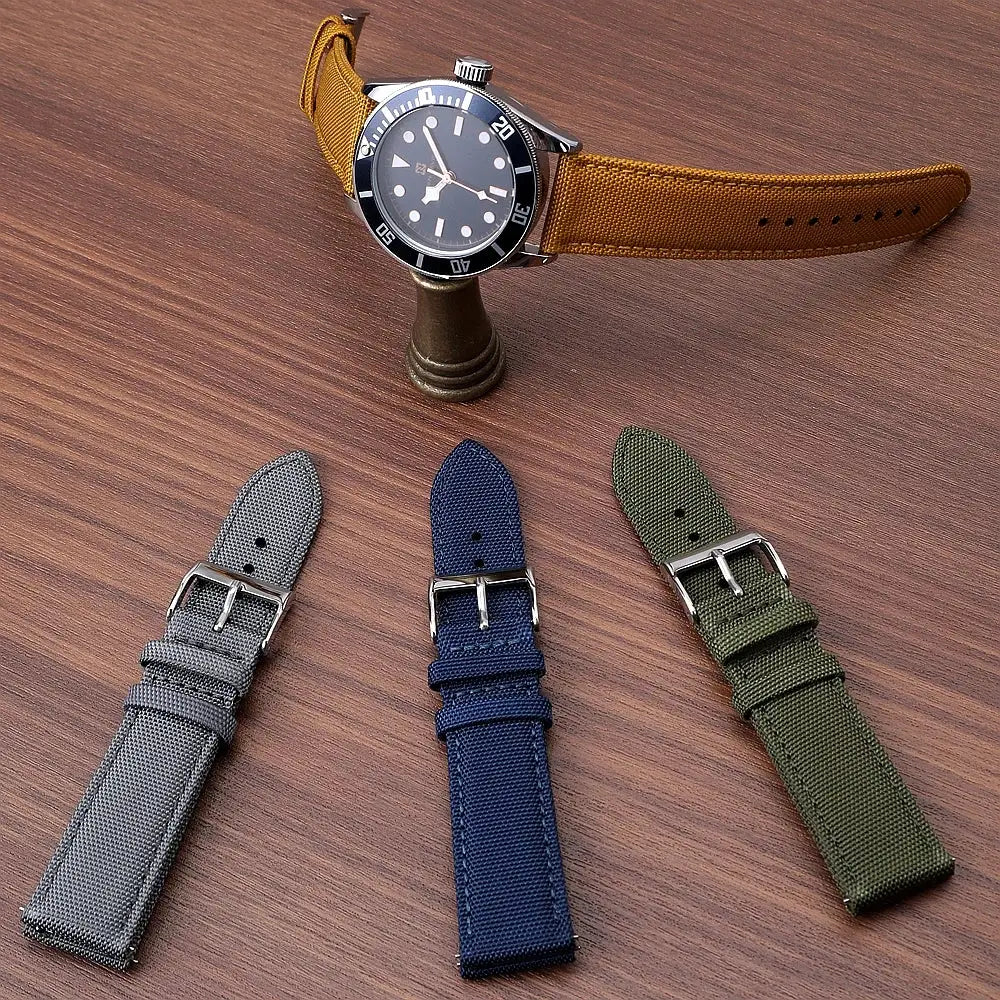 Watch straps by Simples Market: sailcloth nylon, two-sided, quick-release, four straps in gray, navy, olive, tan.